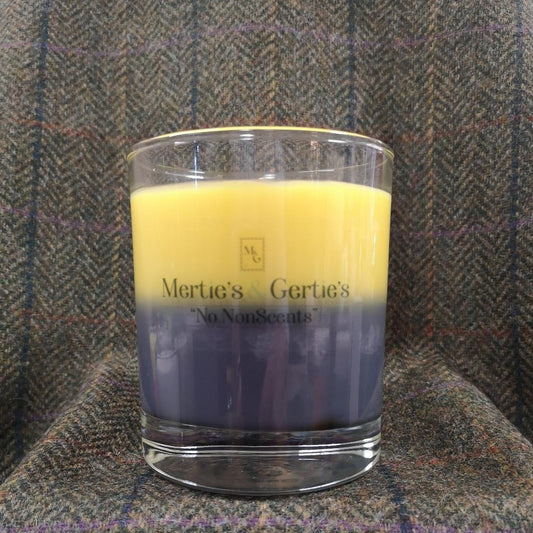 A candle where the top half is yellow and the bottom half is grey. It's in a clear glass to allow the colours to be seen and as the candle burns down a third colour is created. Burning time for the candle is between 40- 42 hours. Made from Soy & Coconut vegan friendly & Cruelty free wax.