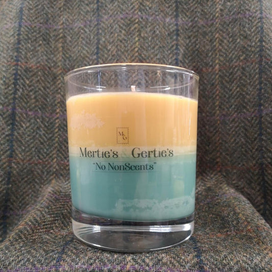 A candle where the top half is orange and the bottom half is green. Half way through the candle will create a third colour. It's in a clear glass with a burn time of between 40 -42 hours.