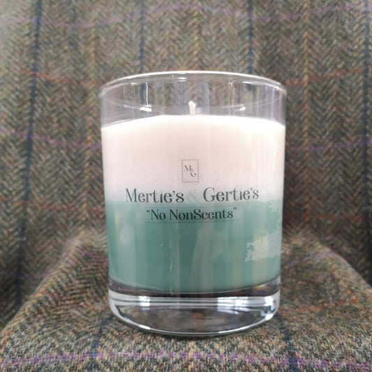 A candle where the top half is cream and the bottom half is green. It's in a clear glass and can last for up to 40hrs